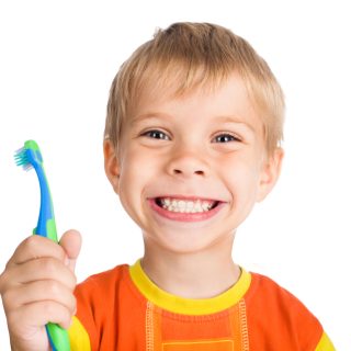 Smiling little boy with toothbrush